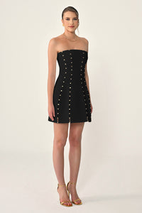 Black strapless dress with button details on a white background