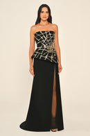 Black strapless gown with gold detailing on a beige background