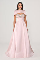 Pink evening gown with embellished top on a white background