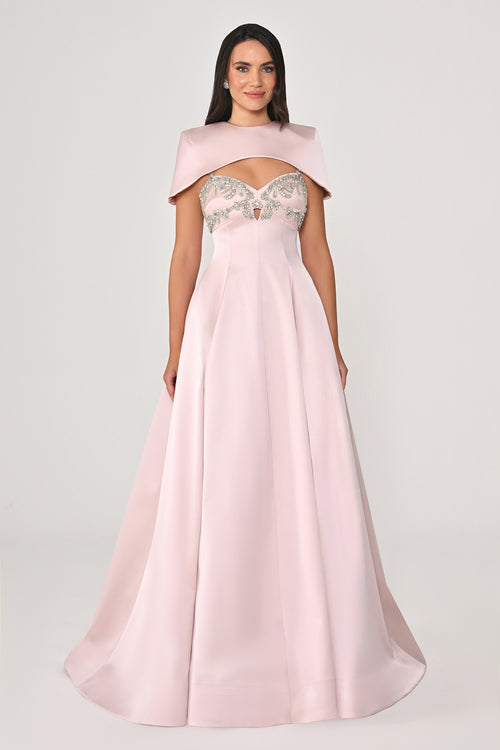 Pink evening gown with embellished top on a white background