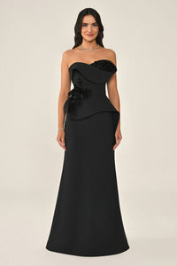Black strapless gown with floral details on a beige background