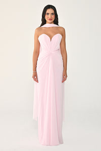 Woman wearing a strapless pink gown on a white background