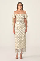 Woman wearing a beige off-shoulder lace dress on a white background