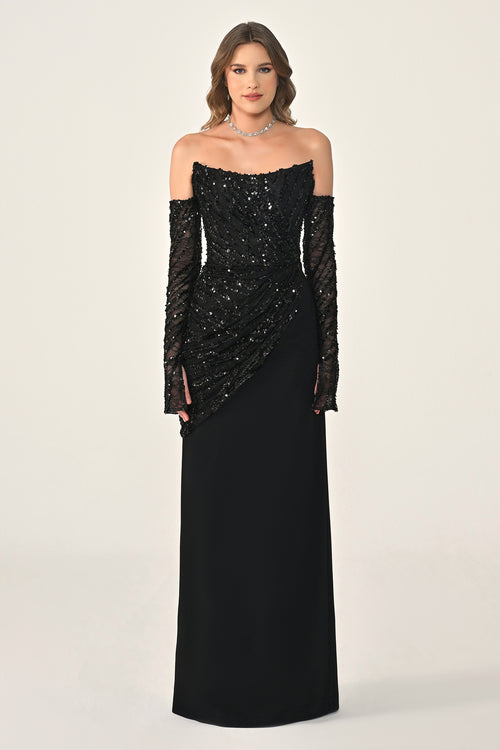 Woman wearing a black evening gown with long gloves on a white background