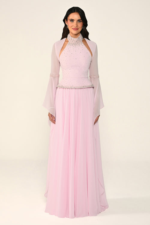 Woman wearing a light pink traditional outfit with a sheer overlay on a white background