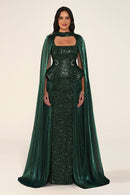 Celestara Dress in Green: sequin column gown with a square neckline, peplum hip detail, stone-embellished waist and a flowing organza cape