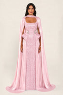 Celestara Dress in Pink: sequin column gown with a square neckline, peplum hip detail, stone-embellished waist and a flowing organza cape