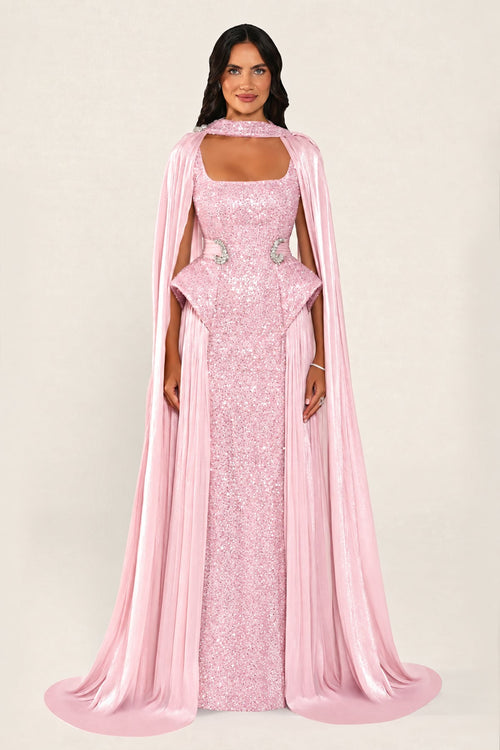 Celestara Dress in Pink: sequin column gown with a square neckline, peplum hip detail, stone-embellished waist and a flowing organza cape