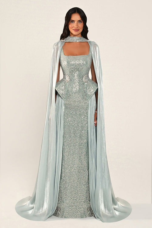 Celestara Dress in Turquoise: sequin column gown with a square neckline, peplum hip detail, stone-embellished waist and a flowing organza cape