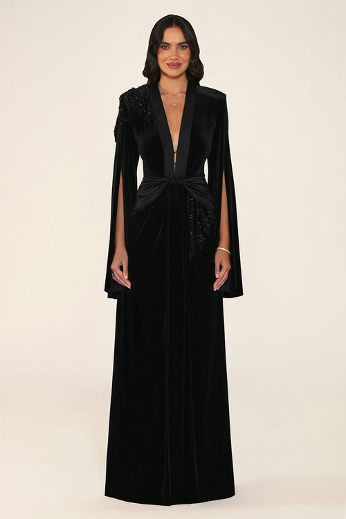 Noctavia Dress in Black: velvet gown with padded shoulders, a plunging satin-trimmed V-neck, long split cape sleeves and a satin knot at the waist