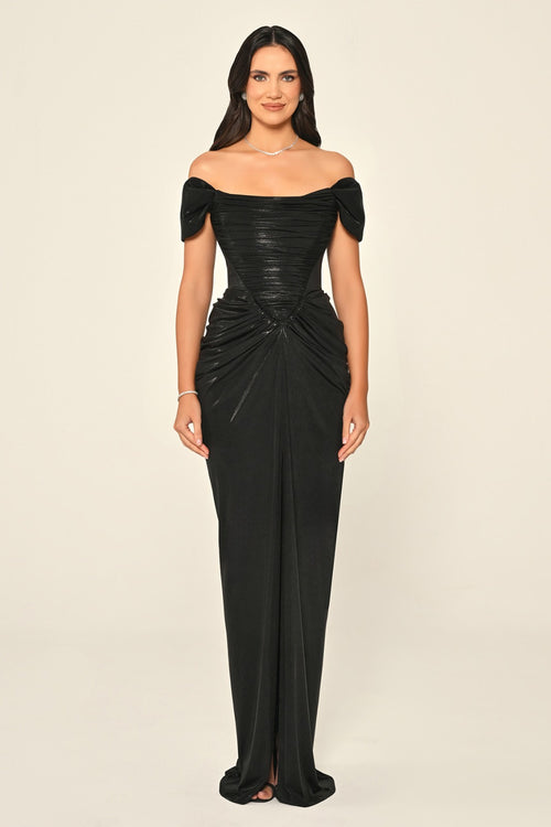 Woman wearing a black off-shoulder gown on a beige background