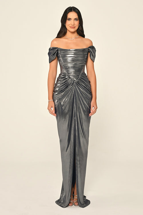 Woman wearing a silver off-shoulder gown on a beige background