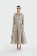 Woman wearing a beige suit with a white background