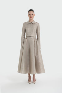 Woman wearing a beige suit with a white background