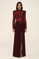 Vespera burgundy maxi evening dress with long sleeves, high neck, sequinned floral lace bodice and tie-waist skirt with leg slit